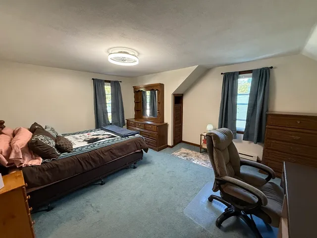 a bedroom with furniture and a chair