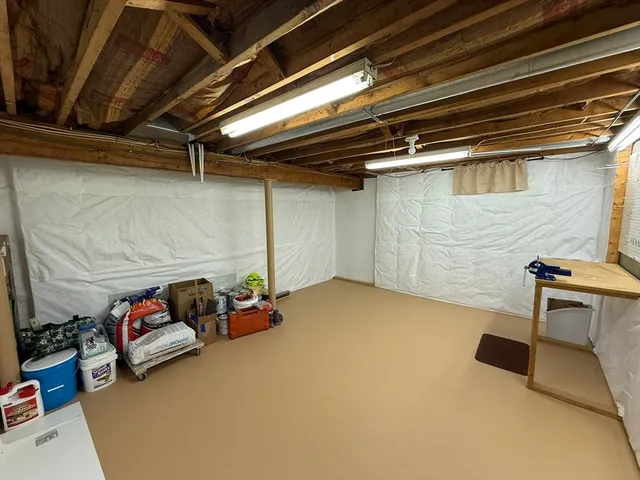 a blue bed sitting in a room next to a window