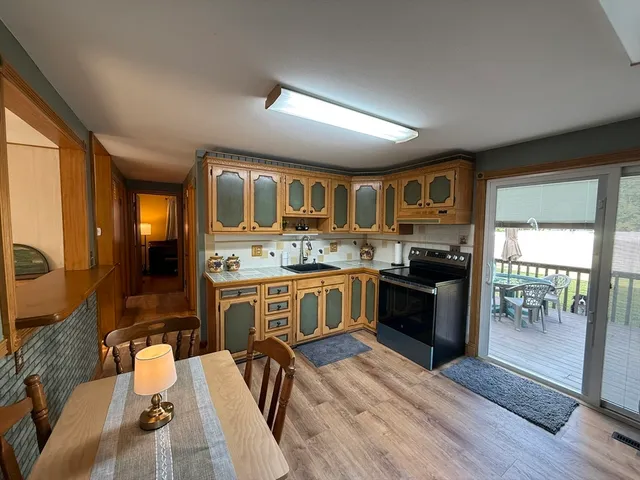 a kitchen with a sink stove and refrigerator