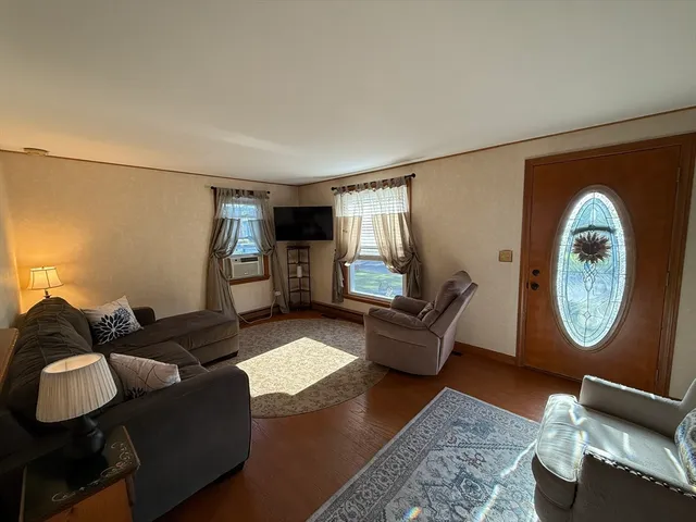 a living room with furniture and a mirror