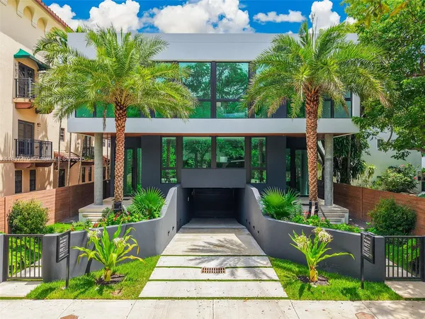 a view of a patio with table and chairs plants and wooden fence