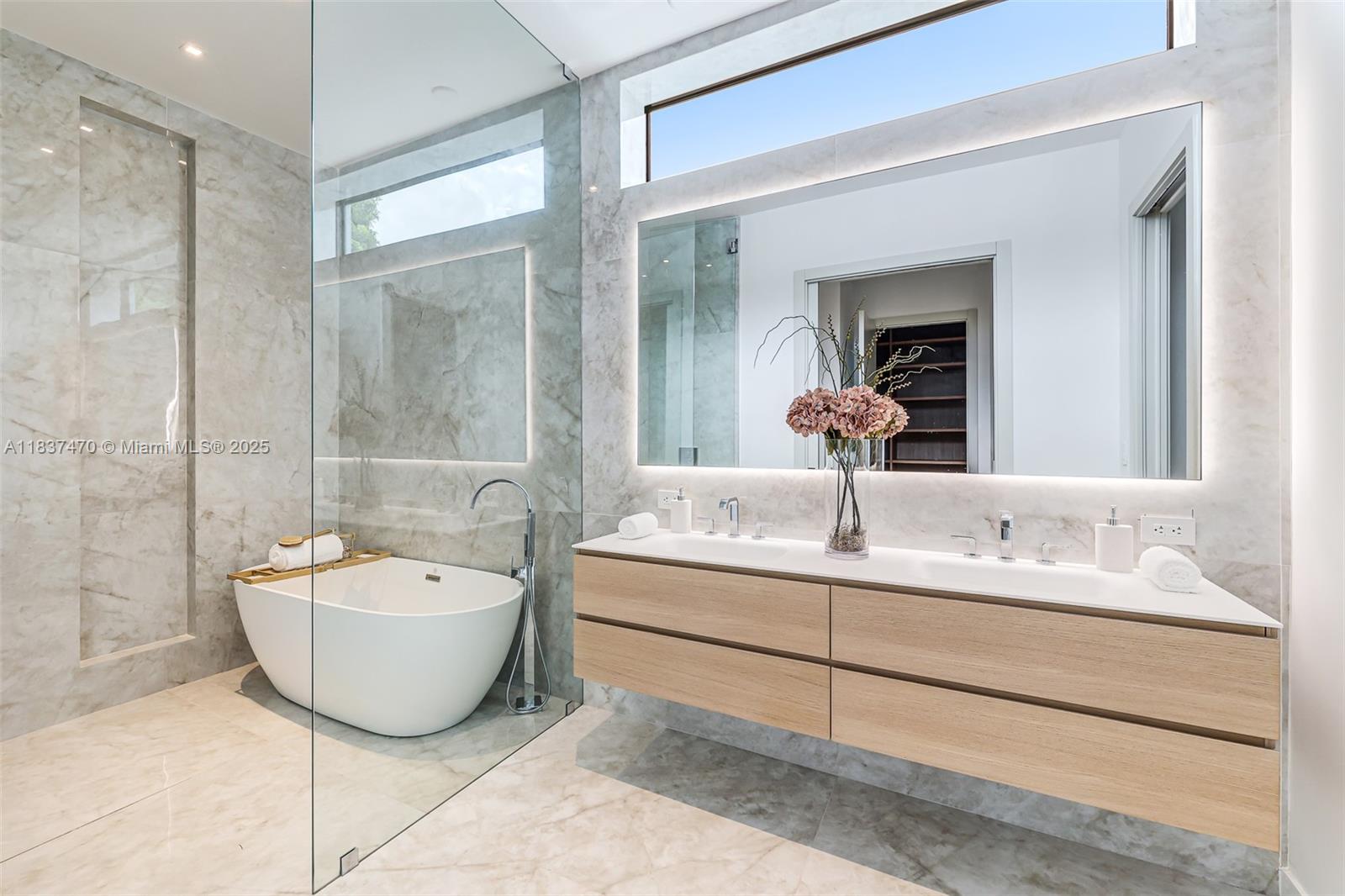 2824 Coconut Avenue, Unit 2824 Miami, FL 33133 - Photo 14 of 31 a bathroom with a sink and a mirror