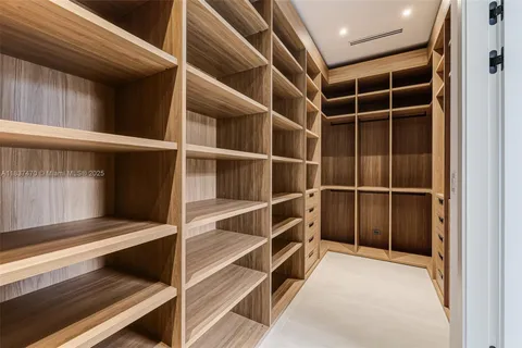 a view of an empty room with a staircase