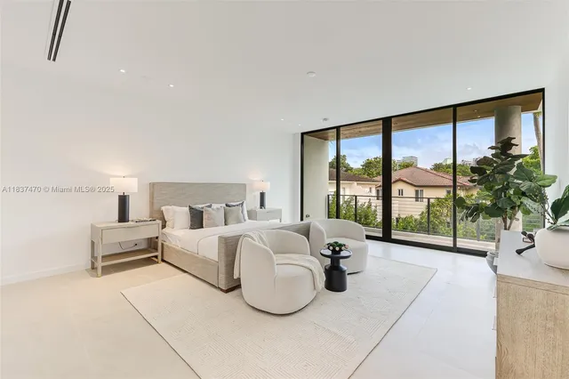 a living room with furniture large windows and large windows