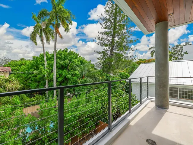 a view of a balcony with a tree