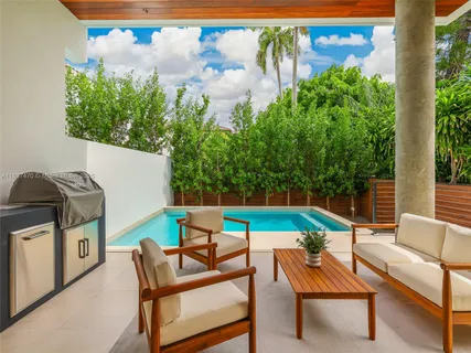 a living room with furniture a large window and a table