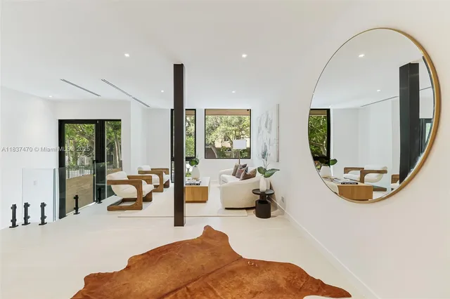 a living room with furniture and a mirror