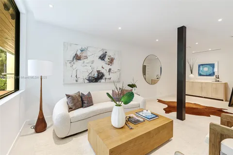 a living room with furniture and a mirror