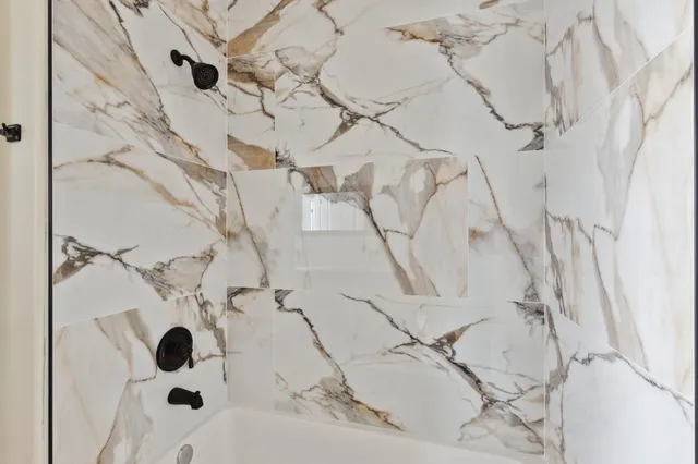 a bathroom with a bathtub and shower