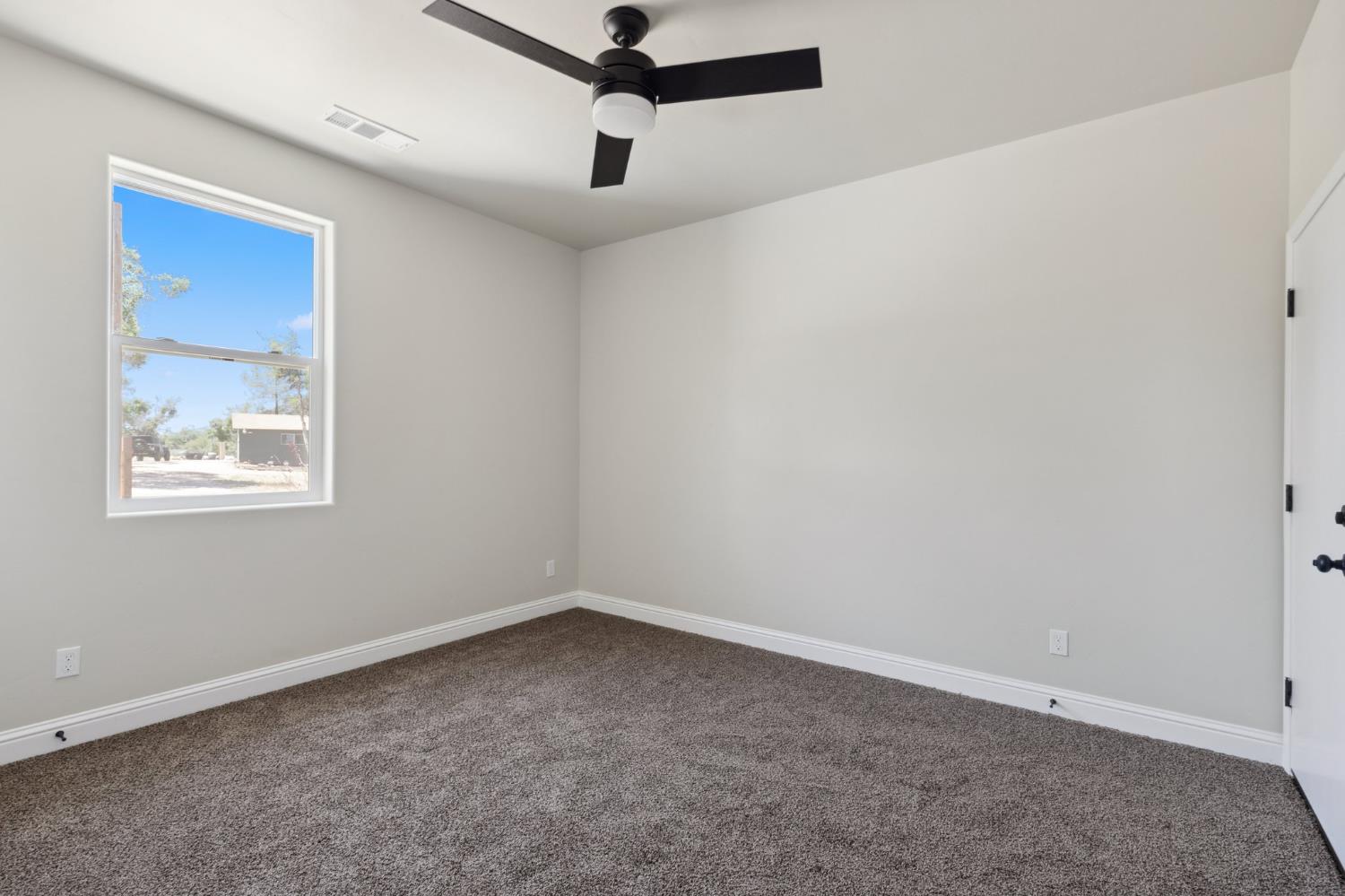 31007 Revis Road Coarsegold, CA 93614 - Photo 17 of 41 an empty room with a window and a fan