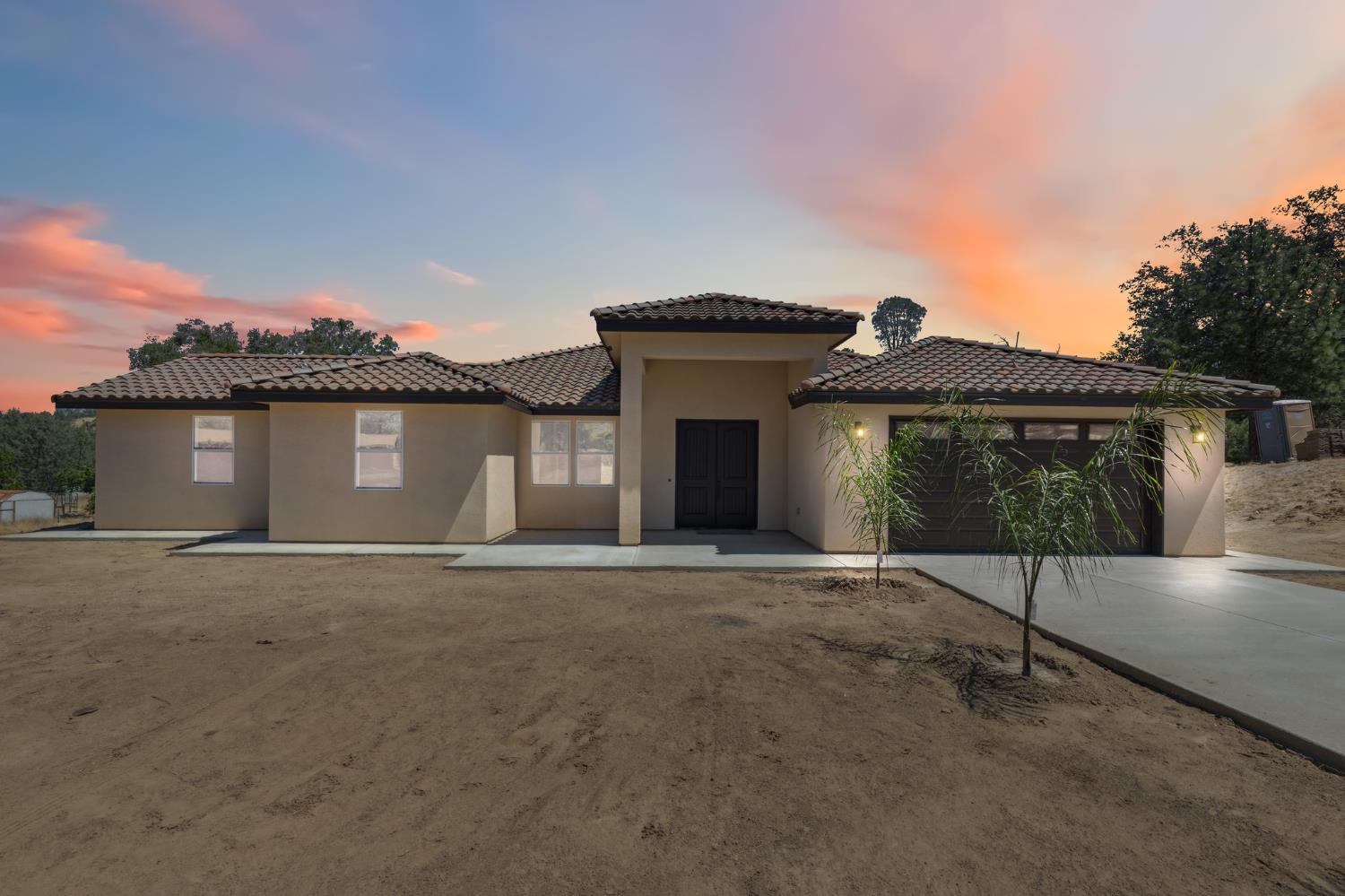 31007 Revis Road Coarsegold, CA 93614 - Photo 3 of 41 a front view of a house with a garden and parking