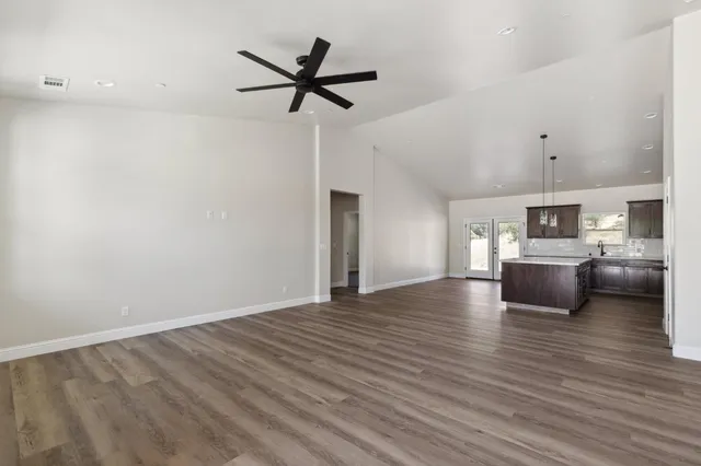 a view of a kitchen with furniture and wooden floor