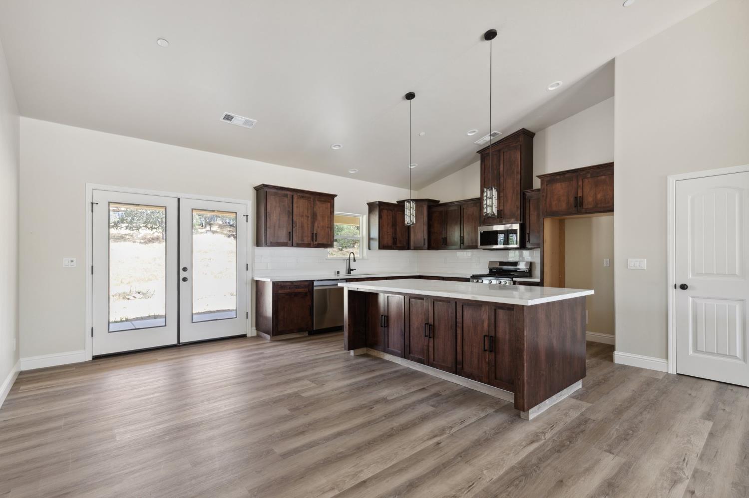 31007 Revis Road Coarsegold, CA 93614 - Photo 8 of 41 a kitchen with stainless steel appliances a sink a stove top oven a sink and cabinets
