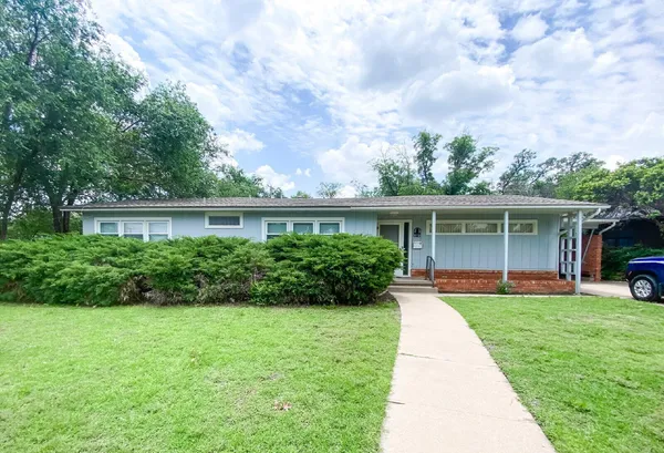 a front view of a house with a yard and porch