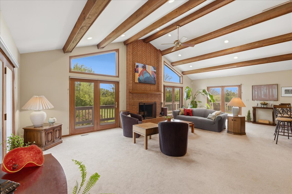 520 Merri Oaks Road Barrington Hills, IL 60010 - Photo 12 of 43 a living room with furniture fireplace and large windows