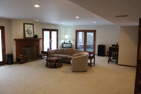a living room with furniture fireplace and window