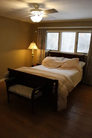 a bedroom with a bed and a window