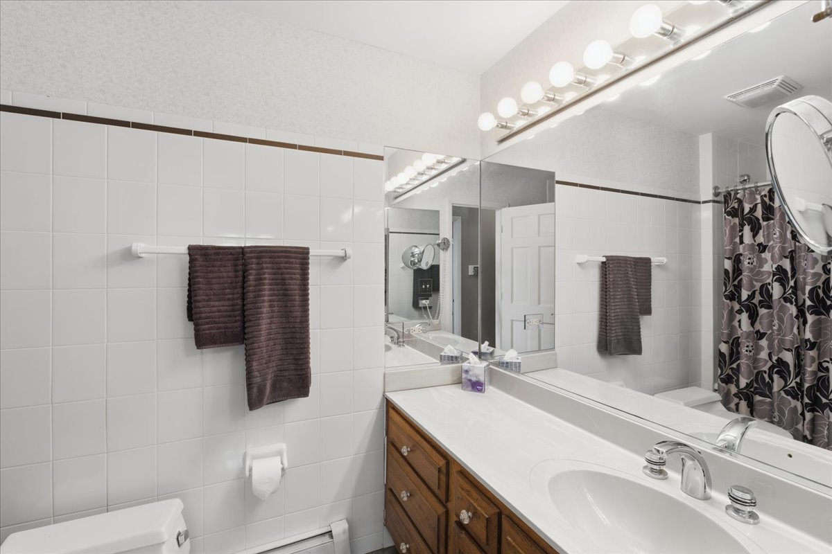 520 Merri Oaks Road Barrington Hills, IL 60010 - Photo 19 of 43 a bathroom with a sink double vanity granite and a mirror