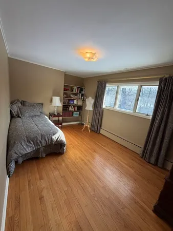 a bedroom with a bed and window