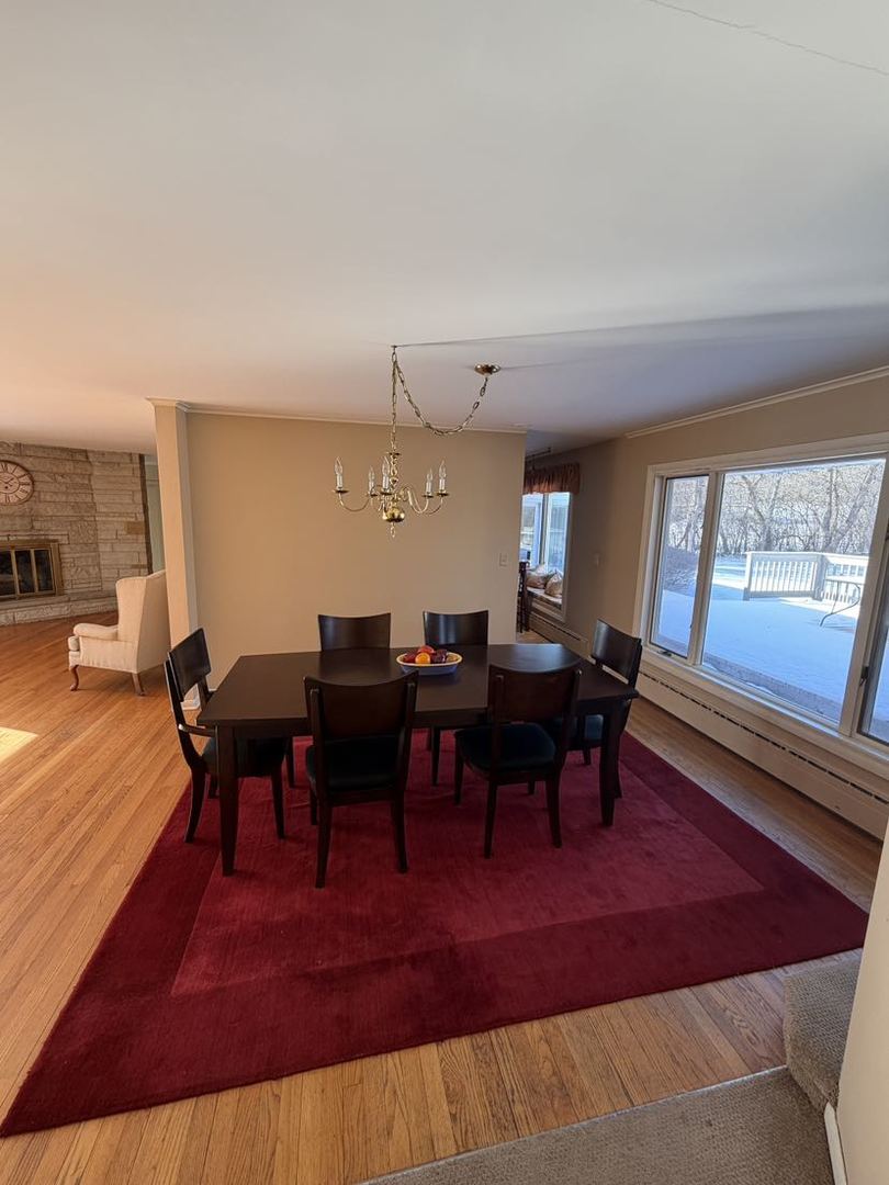 520 Merri Oaks Road Barrington Hills, IL 60010 - Photo 30 of 31 a view of a big room with dining room windows and wooden floor