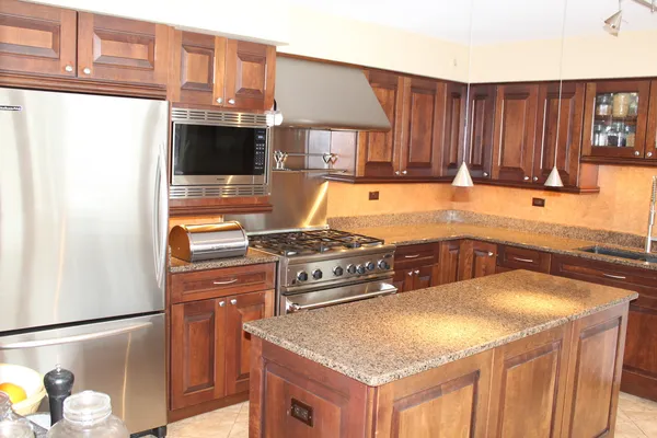 a kitchen with stainless steel appliances granite countertop a sink stove and refrigerator