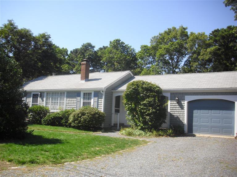19 Uncle Henrys Road Mashpee, MA 02649 - Photo 1 of 15 a front view of a house with garden