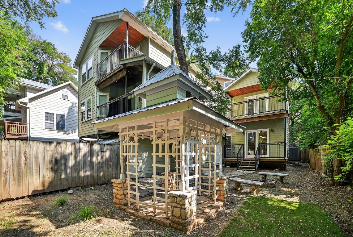 2003 Griswold Lane, Unit A Austin, TX 78703 - Photo 5 of 21 Rear view of house featuring a balcony, a fenced backyard, and a wooden deck