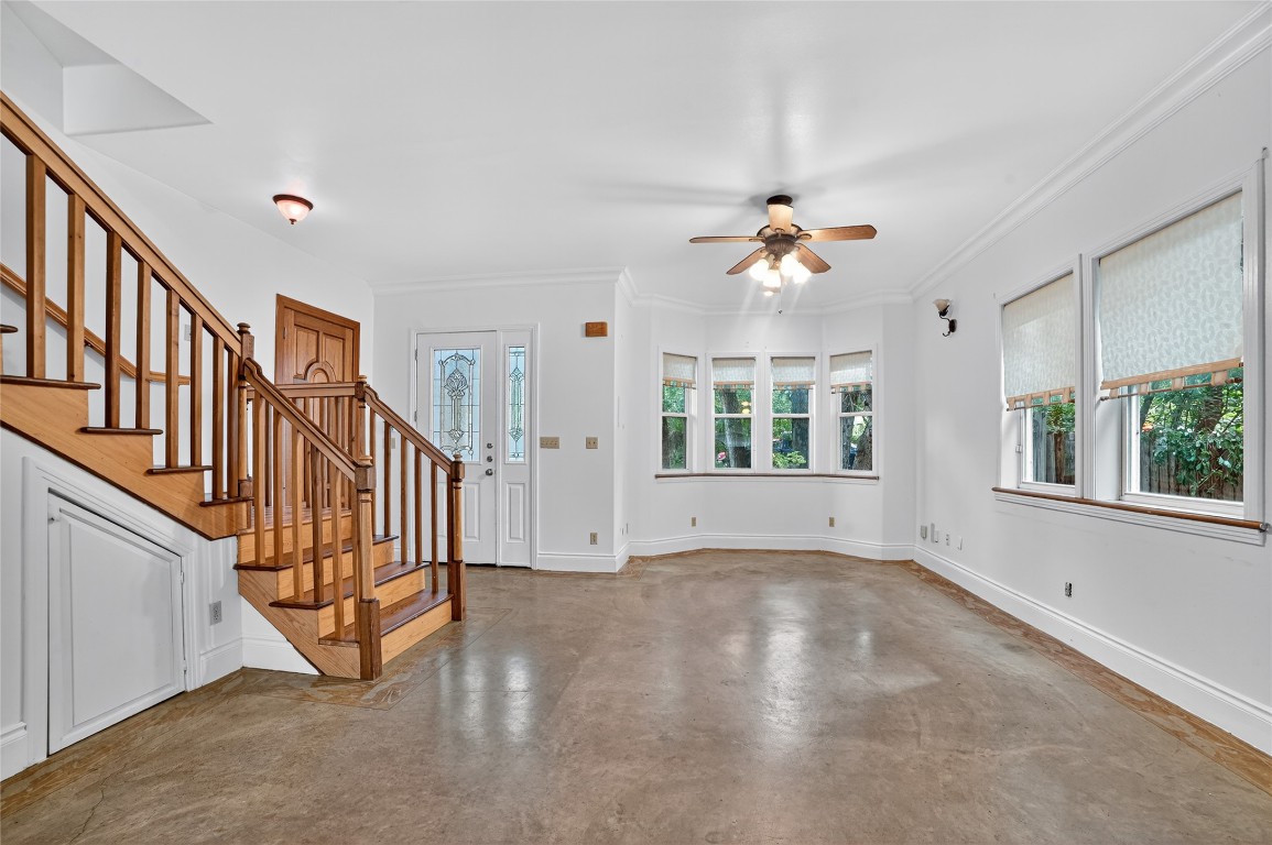 2003 Griswold Lane, Unit A Austin, TX 78703 - Photo 9 of 21 Entryway with concrete flooring, ornamental molding, stairs, and a ceiling fan