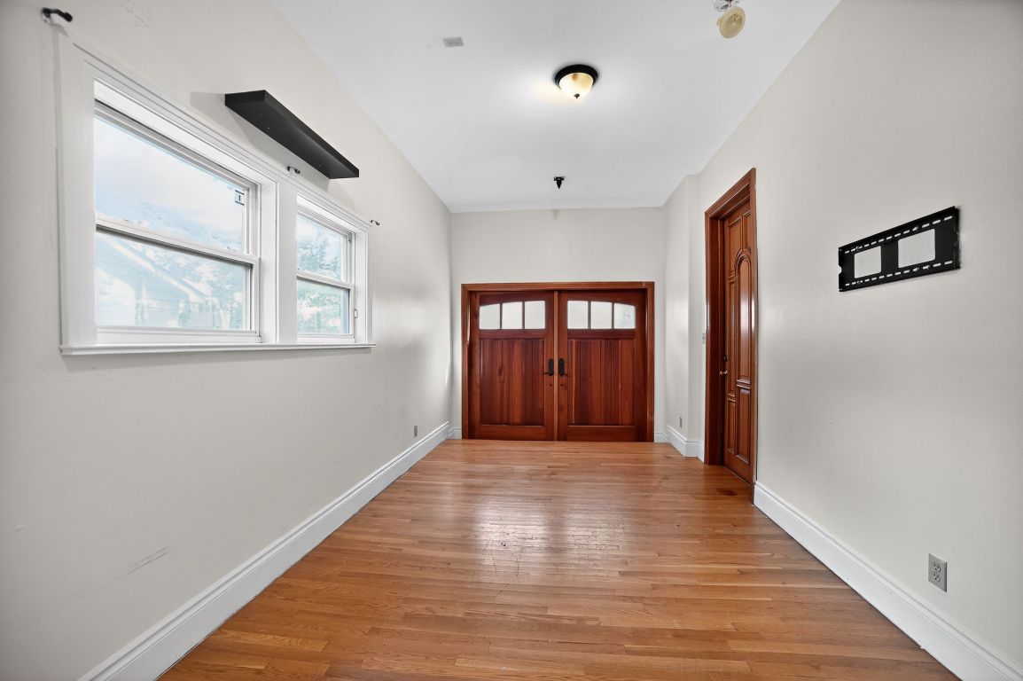 2003 Griswold Lane, Unit A Austin, TX 78703 - Photo 10 of 21 Doorway featuring light wood-style flooring and baseboards