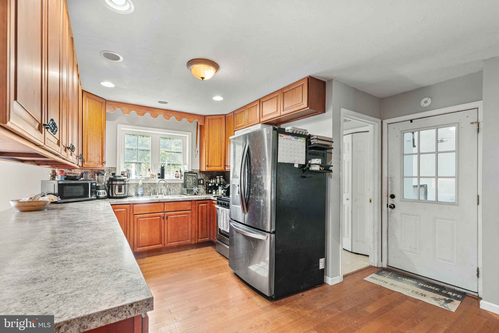 225 Pine Ridge Road Aspers, PA 17304 - Photo 7 of 42 a kitchen with stainless steel appliances granite countertop a refrigerator and a sink