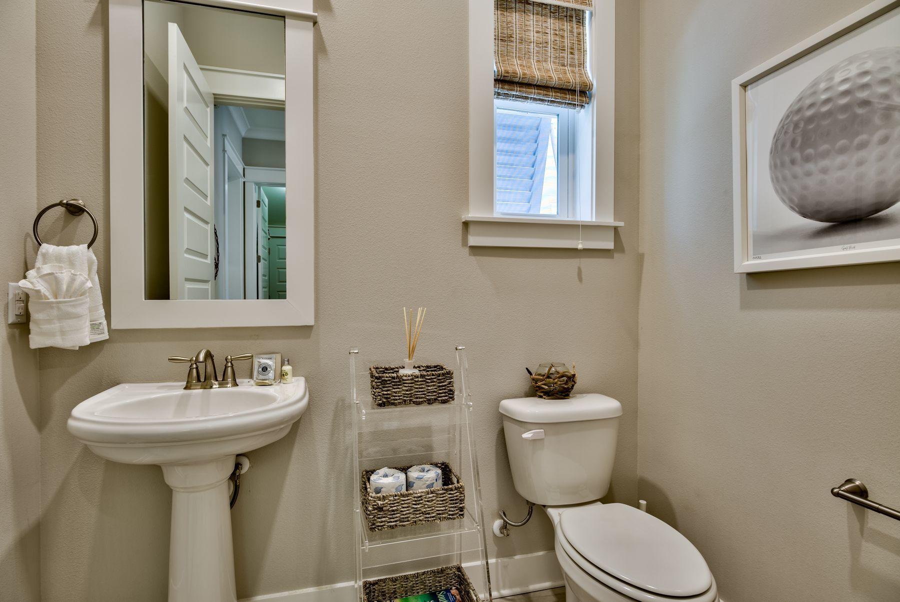 35 Milestone Dr Inlet Beach, Unit A Inlet Beach, FL 32461 - Photo 15 of 31 a bathroom with a sink a mirror and a toilet