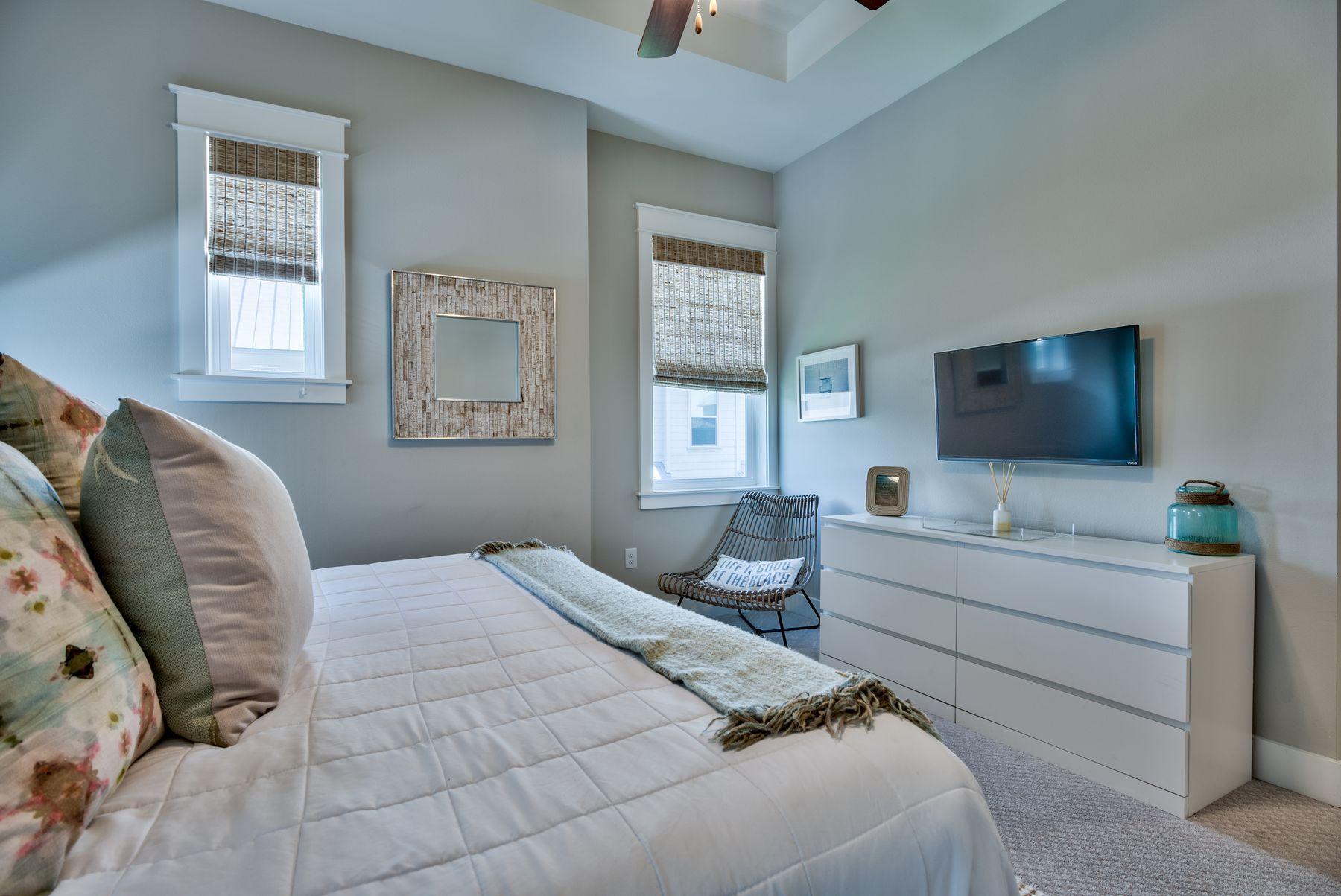35 Milestone Dr Inlet Beach, Unit A Inlet Beach, FL 32461 - Photo 17 of 31 a bedroom with a large bed and a flat screen tv