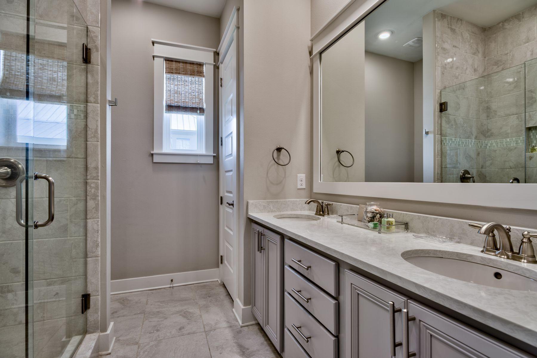 35 Milestone Dr Inlet Beach, Unit A Inlet Beach, FL 32461 - Photo 19 of 31 a bathroom with a sink double vanity and a mirror