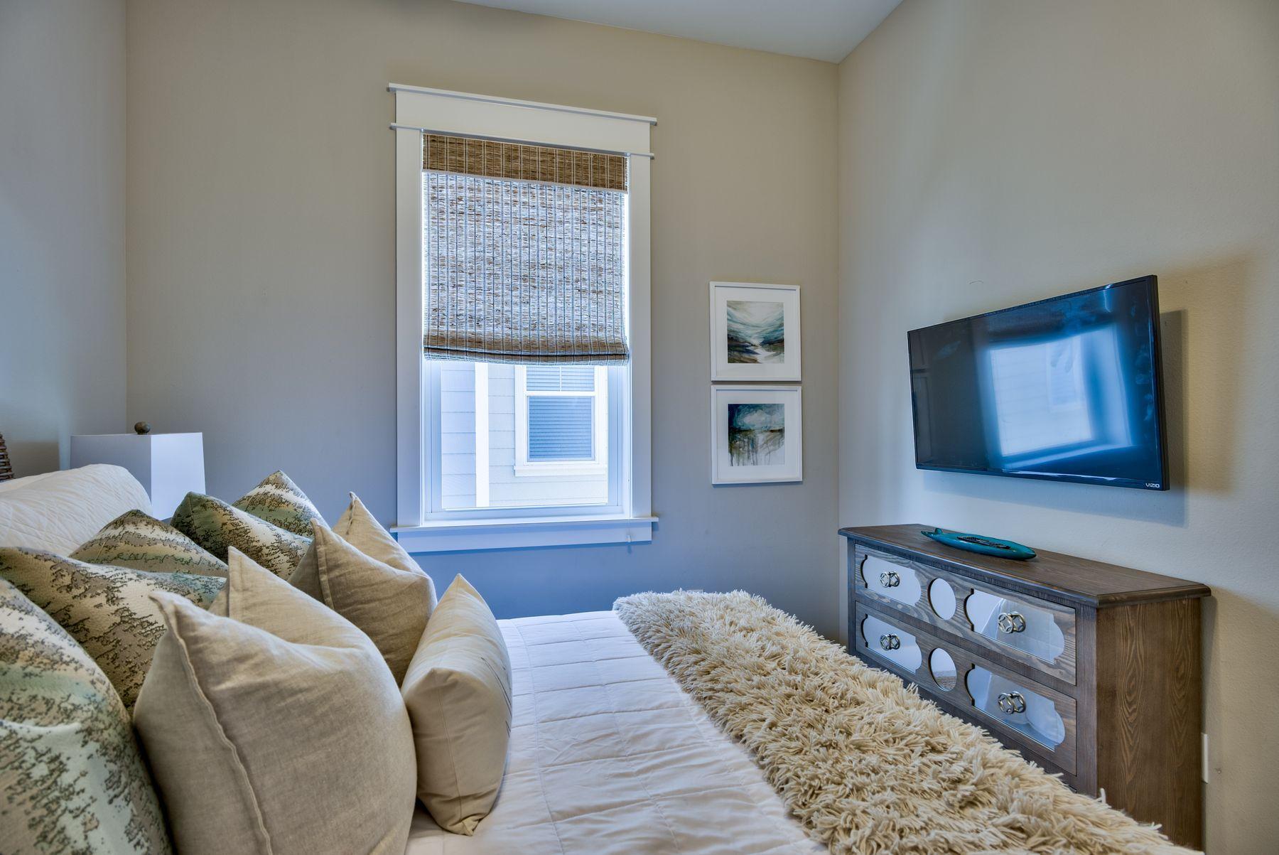35 Milestone Dr Inlet Beach, Unit A Inlet Beach, FL 32461 - Photo 25 of 31 a bedroom with a bed and a window