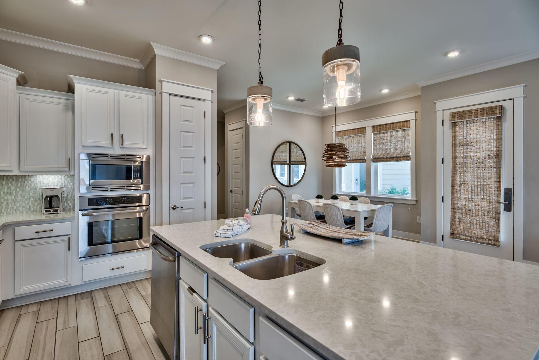 35 Milestone Dr Inlet Beach, Unit A Inlet Beach, FL 32461 - Photo 9 of 31 a kitchen with counter top space a sink and stainless steel appliances