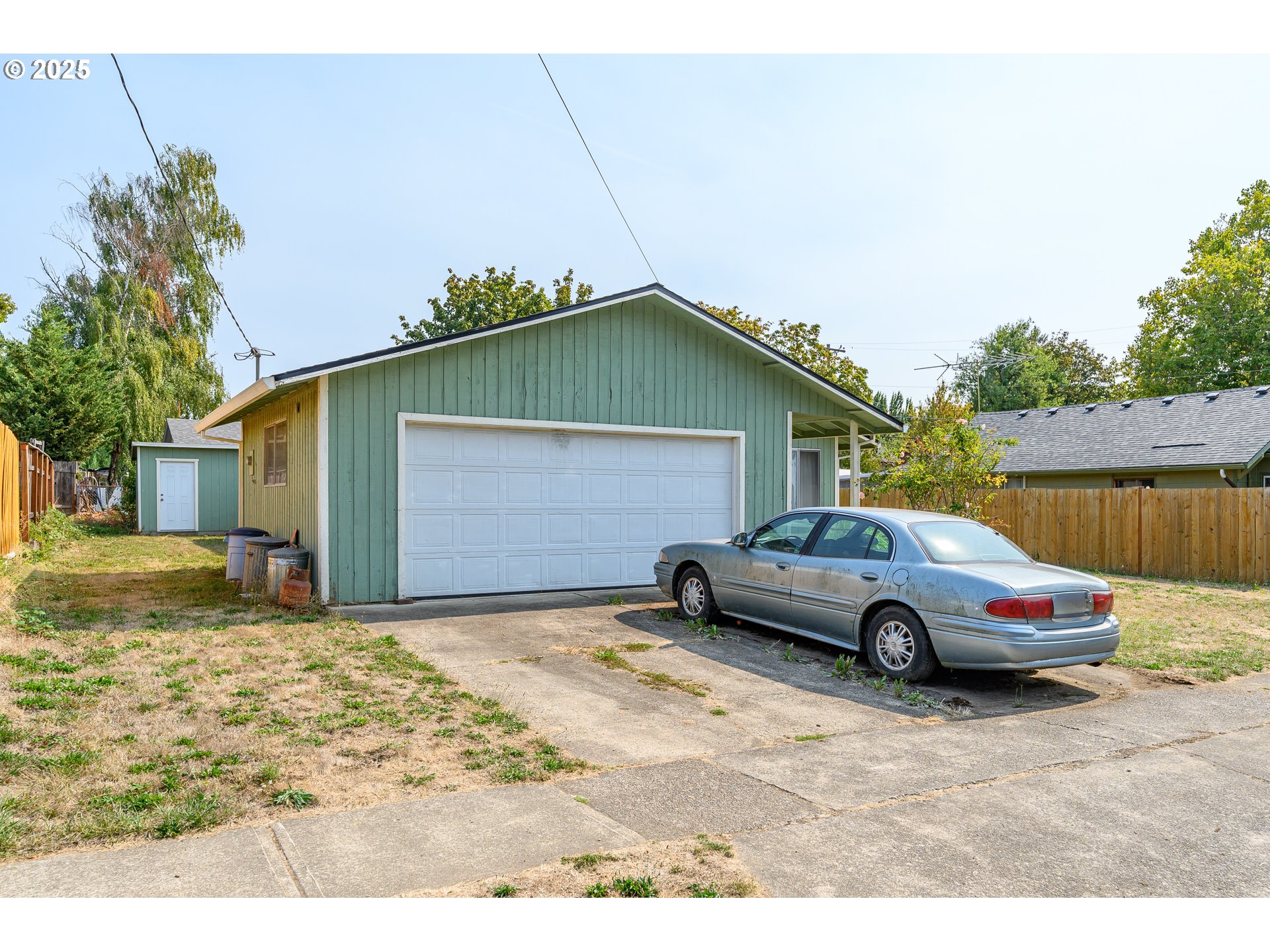 210 South Church Street Newberg, OR 97132 - Photo 12 of 34 a blue car parked in front of a house