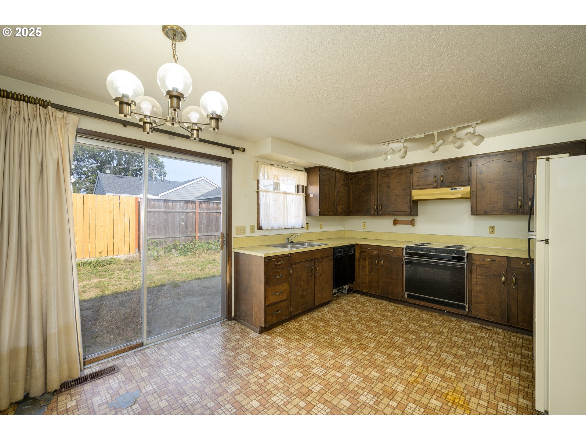 210 South Church Street Newberg, OR 97132 - Photo 2 of 34 a kitchen with granite countertop a sink cabinets and stainless steel appliances
