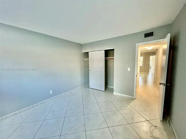 a view of an empty room and a bathroom