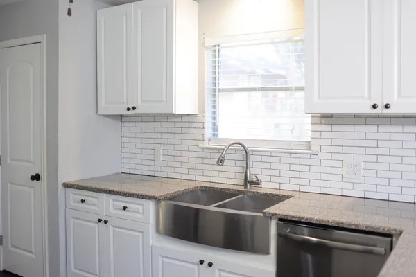 a kitchen with granite countertop a refrigerator and a stove