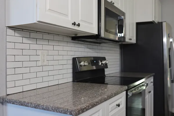 a view of a livingroom with wooden floor and a ceiling fan
