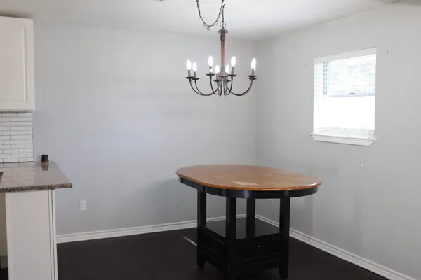 a kitchen with granite countertop a sink a stove and cabinets
