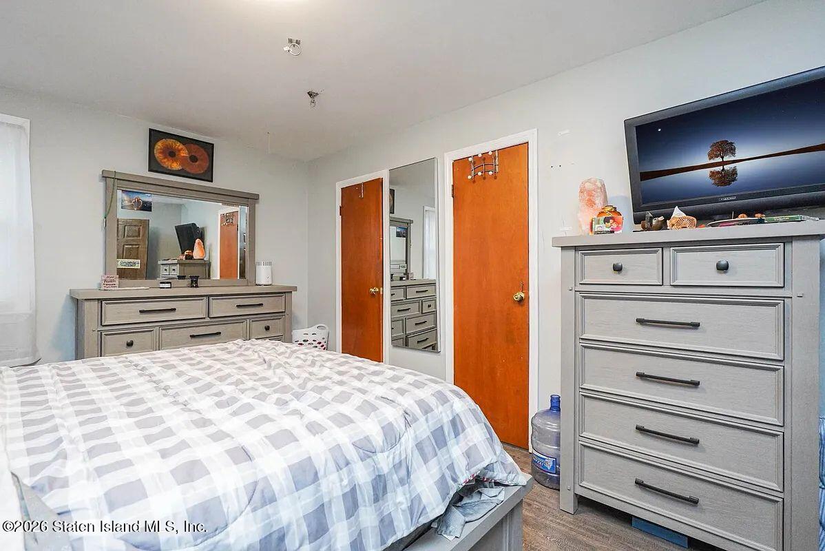 202 Watchogue Road Staten Island, NY 10314 - Photo 14 of 19 a bedroom with a bed and a flat screen tv