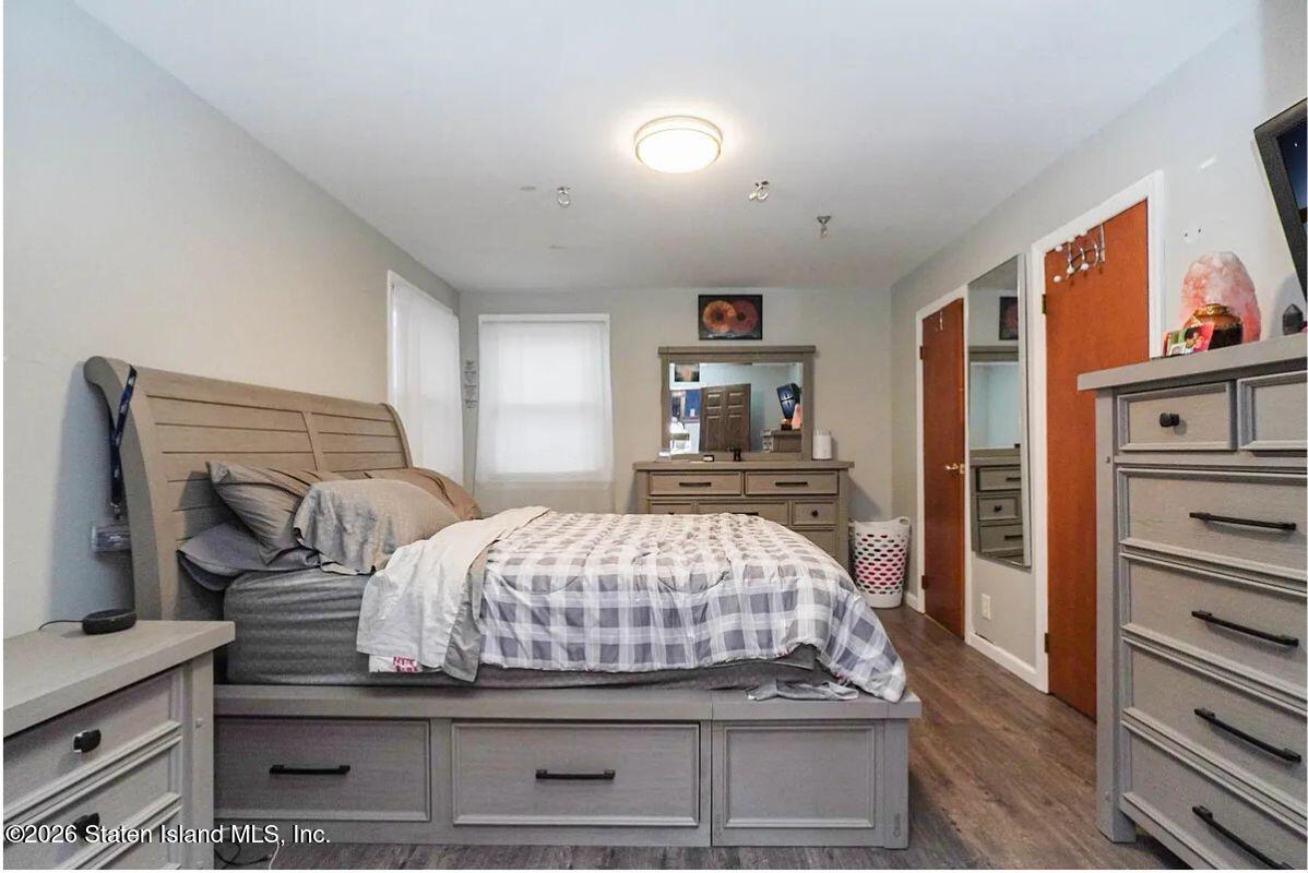 202 Watchogue Road Staten Island, NY 10314 - Photo 16 of 19 a bedroom with a bed and wooden floor