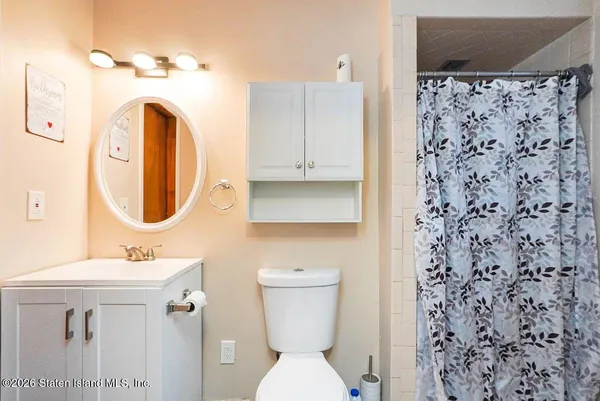 a bathroom with a sink a toilet and a mirror