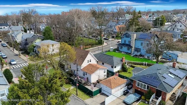 an aerial view of multiple houses with yard