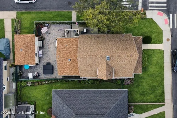 an aerial view of a house with a garden and a yard