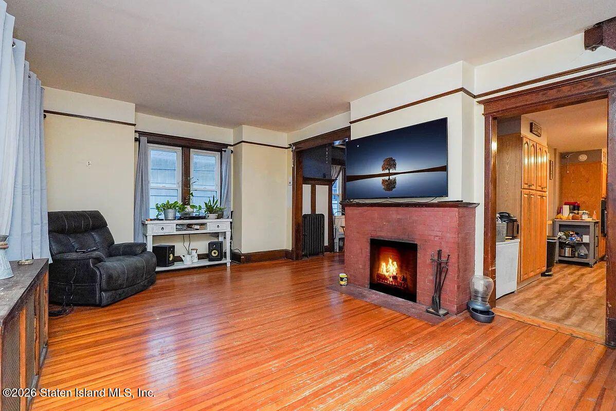 202 Watchogue Road Staten Island, NY 10314 - Photo 7 of 19 a living room with furniture and a fireplace