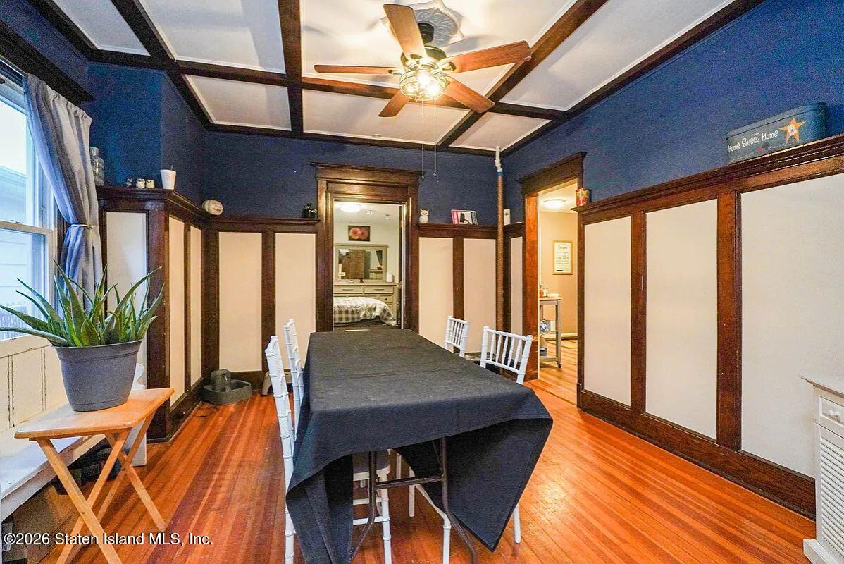 202 Watchogue Road Staten Island, NY 10314 - Photo 8 of 19 a view of a dining room with furniture window and wooden floor