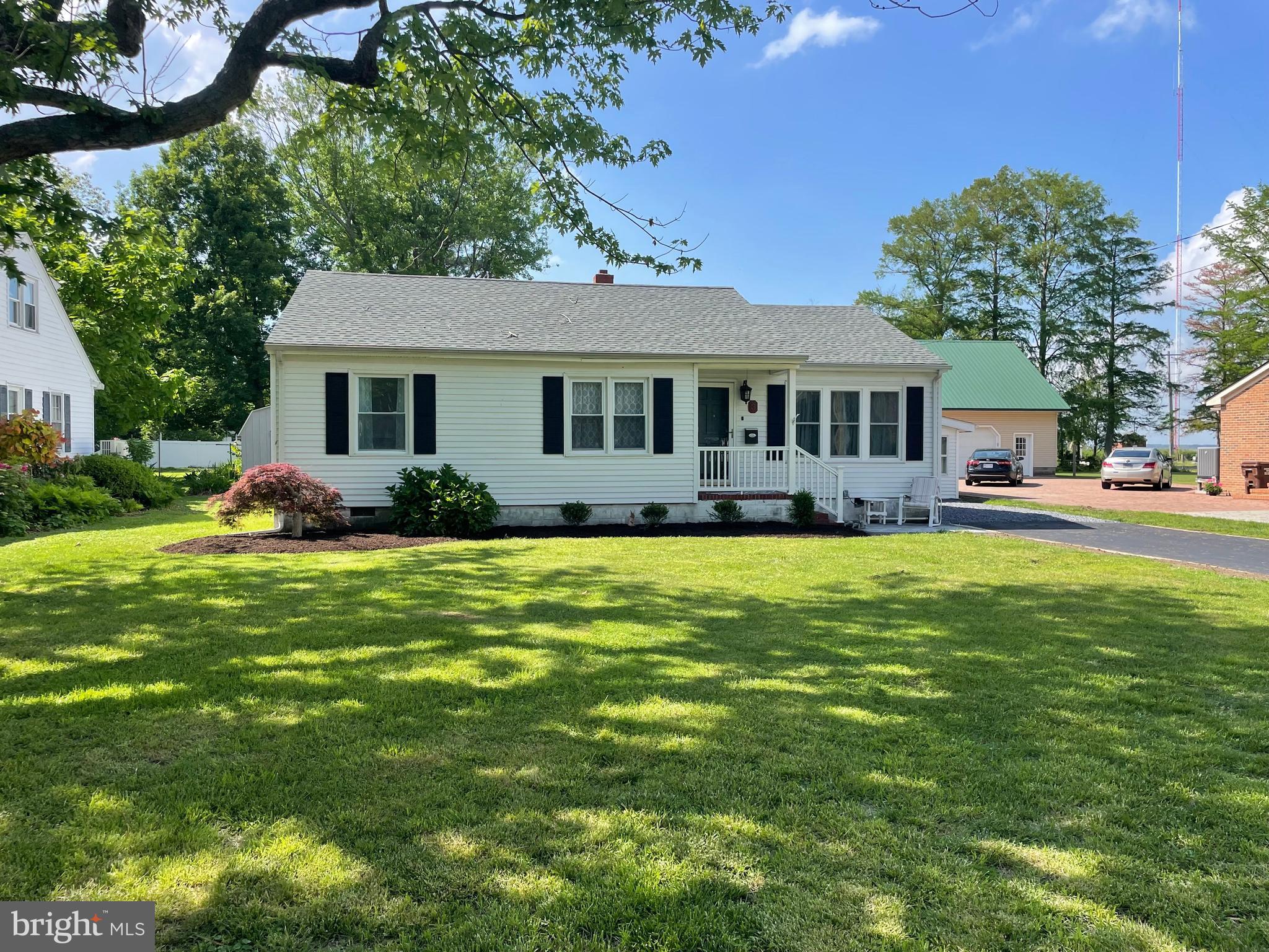 a front view of house with yard and outdoor seating
