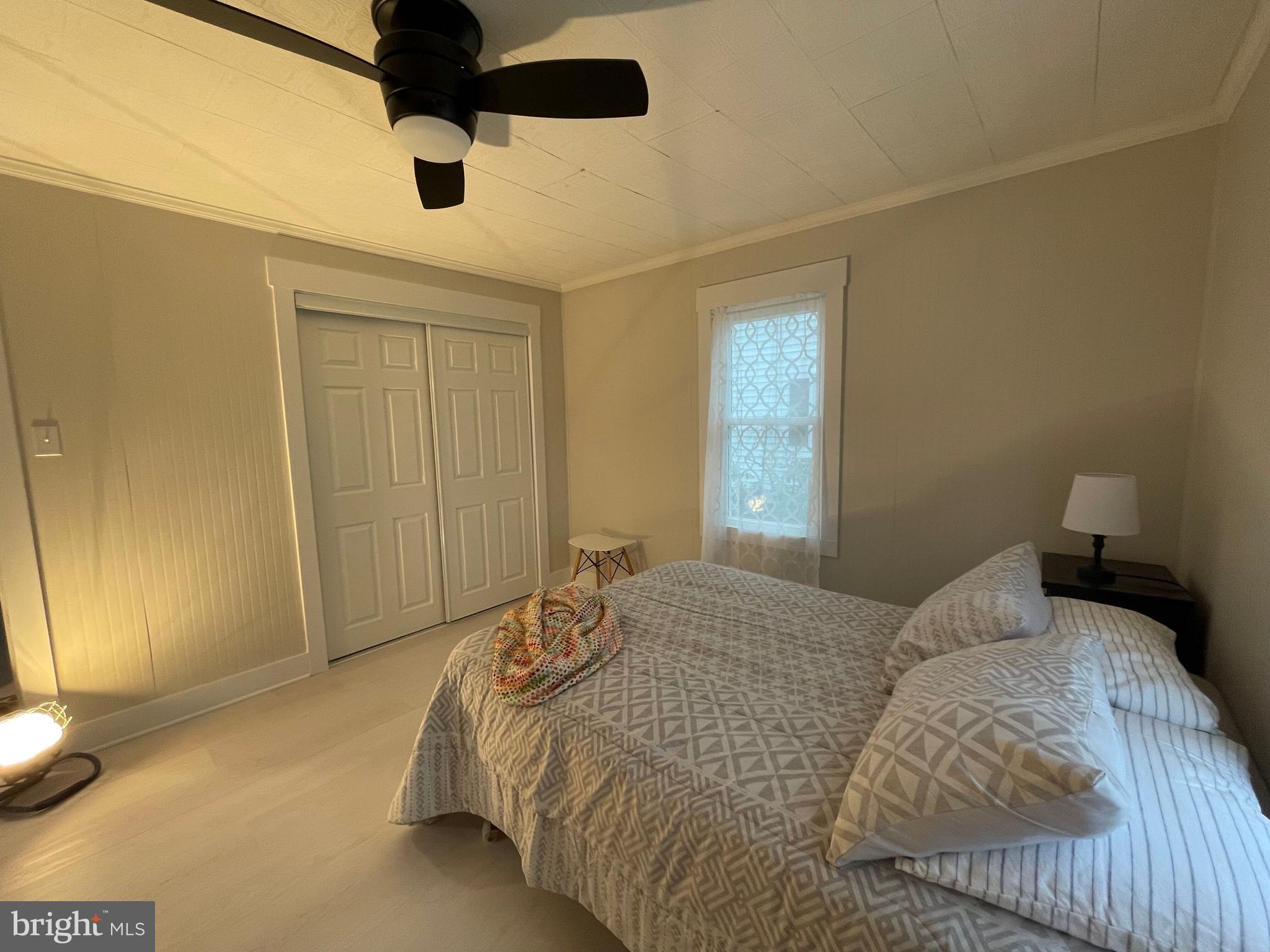 3 Talbot Avenue Cambridge, MD 21613 - Photo 8 of 17 a bedroom with a bed and a chandelier